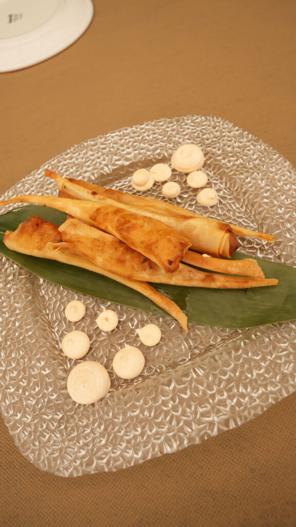 Aperitivo crujiente sobre hoja verde en plato de cristal